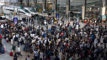 Passengers wait at a train station in Malaga, Spain, after a train connection was interrupted.