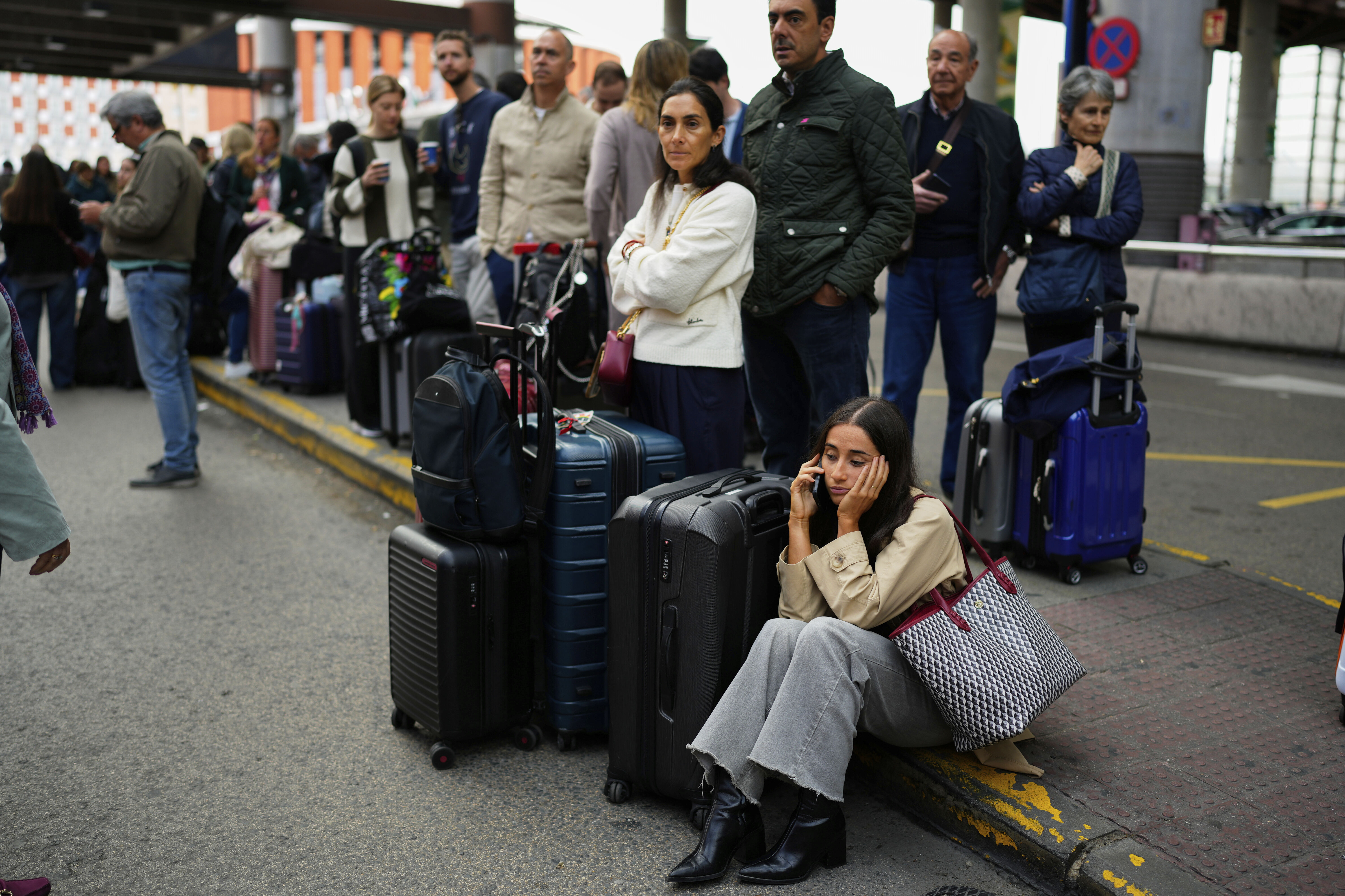 Passengers at a Madrid train station await news about their delayed trains.